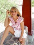 Blonde teen Spring Thomas exposes her bare ass on a public sidewalk