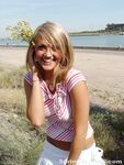 Blonde teen Spring Thomas exposes her bare ass on a public sidewalk