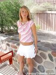 Blonde teen Spring Thomas exposes her bare ass on a public sidewalk