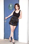 Skinny Chinese babe Li Zheng poses in the black T-shirt and skirt