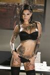 Inked MILF in glasses Bonnie Rotten uncovers her magnificent tits in a solo