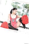 Ebony cheerleader babe poses gorgeously in her sexy red outfit