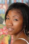Ebony model parts her tight pussy after revealing her hooters while disrobing