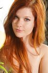 Pale redhead Mia Sollis fingers her hairless twat after taking off her undies