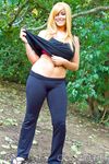 Brassy blonde fatty Tasha Cole removes shirt outside to pose in yoga pants