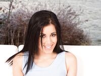 Pretty black eyed and black haired teen presents her nice holes