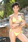 Divine chocolate Honey Gold with tattoos exposes nude body by the pond