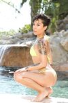 Divine chocolate Honey Gold with tattoos exposes nude body by the pond