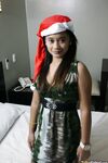 Cute Filipina teen gives a blowjob attired in a Santa Clause cap