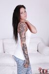 Busty tattooed hottie with pierced nipple getting rid of her clothes