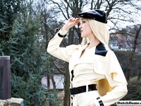 Classy blonde flashes the village below on her patio in latex attire
