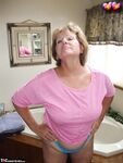 Mature plumper Busty Bliss exposes her large tits in lace underwear