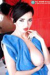 Brunette erotic model Sha Rizel displaying her firm big tits in the bath