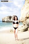 Brunette MILF Lorna Morgan releases her nice melons from bikini on a beach
