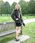 Leg model poses on a country bench in black skirt and pumps