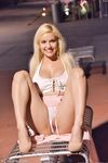 Cute babe Bonnie teases with her huge juggs and sits on rubber toy outdoors