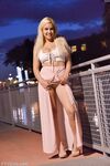 Cute babe Bonnie teases with her huge juggs and sits on rubber toy outdoors