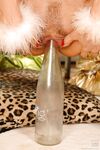 Blonde Santa girl with medium tits drills her twat with a glass bottle