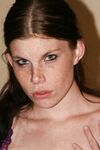 Redhead amateur with freckles displays her shaved vagina atop her bed