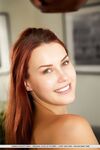 Sexy redhead Charlie Red bares her phat ass and bald slit in a dining room