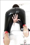 Mature fetish lady in glasses posing in black latex outfit