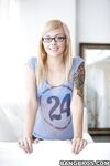 Young blonde cutie Emma Mae in glasses sheds her clothes to spread bald pussy