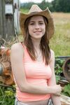 Redhead amateur Eva Green touts her fat ass in front of a box car in straw hat