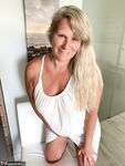 Thick older woman Sweet Susi exposes tan lined tits after hiking up her dress