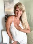 Thick older woman Sweet Susi exposes tan lined tits after hiking up her dress