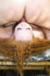 Redhead Audrey Hollander is suspended by ropes before forced throat fucking