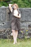 Natural redhead Lara showcases her pussy on a public bench in tan nylons