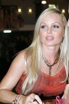 Sexy pornstar MILF Silvia Saint posing fully clothed in jeans and boots