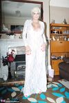 Older woman Dimonty pulls her tits out of long lace dress wearing no panties
