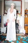 Older woman Dimonty pulls her tits out of long lace dress wearing no panties