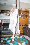 Older woman Dimonty pulls her tits out of long lace dress wearing no panties