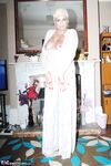 Older woman Dimonty pulls her tits out of long lace dress wearing no panties