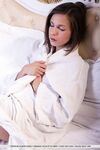 Clothed brunette babe revealing small teen tits from beneath bath robe