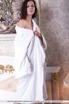 Clothed brunette babe revealing small teen tits from beneath bath robe