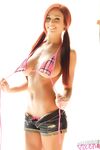 Redhead solo girl Tawnie J hides her huge tits after removing her bikini top