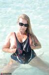 Blonde amateur SweetSusi pulls her tits out form her swimsuit in the pool