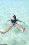 Blonde amateur SweetSusi pulls her tits out form her swimsuit in the pool