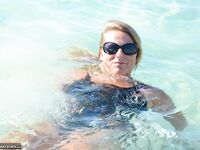 Blonde amateur SweetSusi pulls her tits out form her swimsuit in the pool