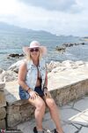 Slutty mature nudist with large tits Chrissy shows her hot curves at the beach