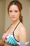 Young solo girl Amy wears a smile while posing non nude in a string bikini