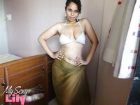 Indian woman lets a boob slip loose from her bra while being a tease