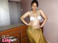 Indian woman lets a boob slip loose from her bra while being a tease