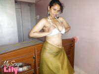 Indian woman lets a boob slip loose from her bra while being a tease