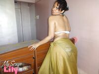 Indian woman lets a boob slip loose from her bra while being a tease