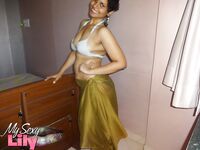 Indian woman lets a boob slip loose from her bra while being a tease