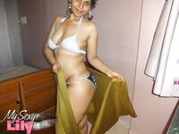 Indian woman lets a boob slip loose from her bra while being a tease